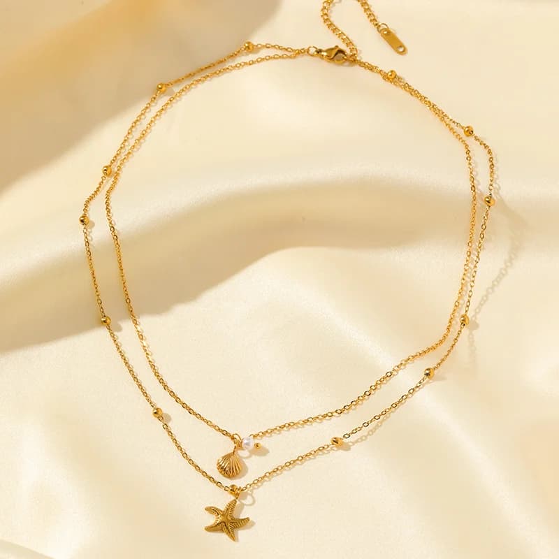 Collier à double chaîne avec pendentifs étoile de mer et coquillage, doré