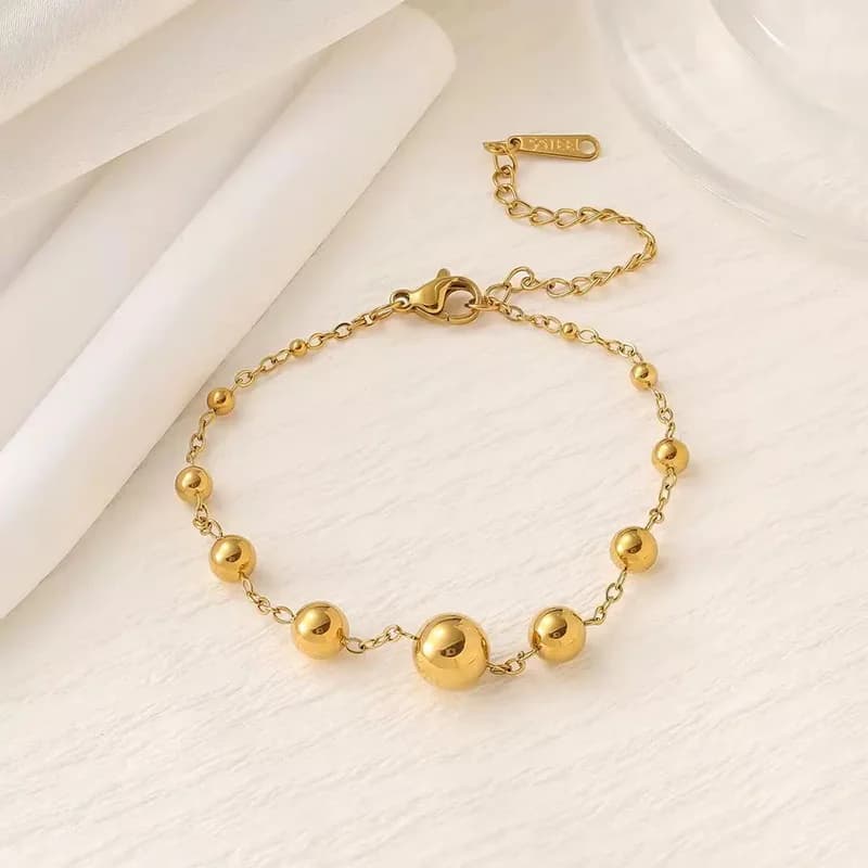 Bracelet jonc chaîne à perles dorées