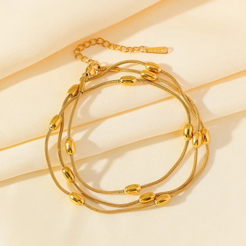 Parure collier et bracelet chaînes superposées dorées