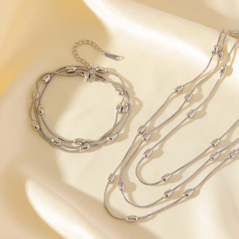 Parure collier et bracelet chaînes superposées dorées